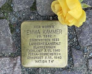 Stolperstein mit gelber Rose